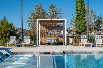 Resort-style pool with tanning ledges and cabanas